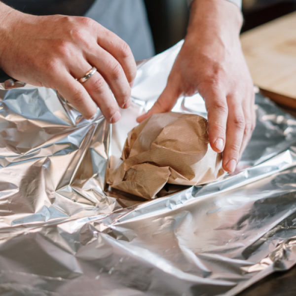 person-wrapping-food-aluminium