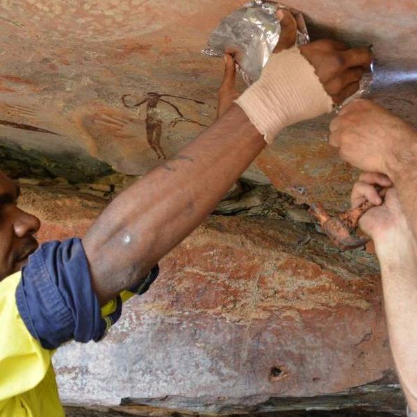 An image of archaeologists figuring out a rock's date