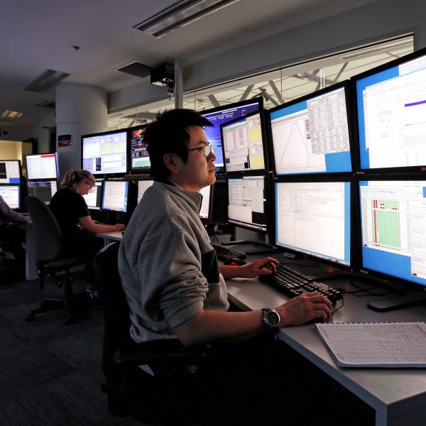 Control room, showing people looking at many computer screens