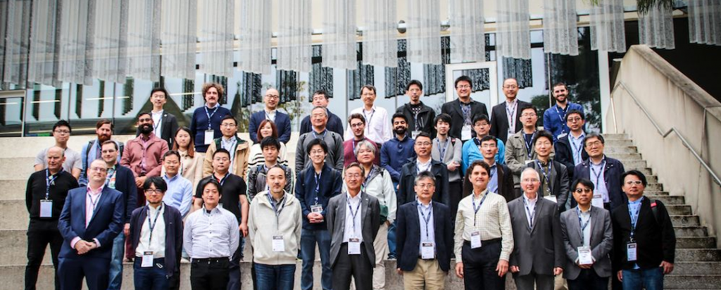 Many people who have attended a workshop, standing of steps