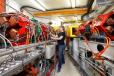 Woman standing next to accelerator transport line