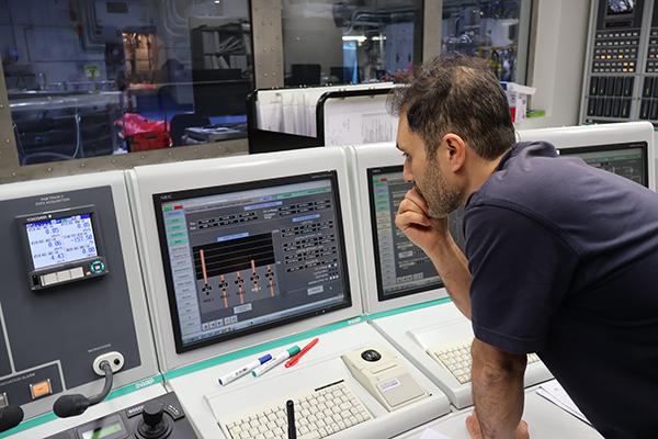 An engineer monitors the start-up neutron detectors in the reactor.j