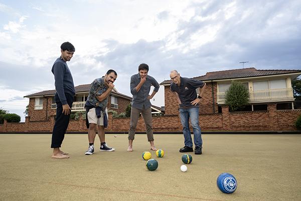 Dr Stephen Holt and participants ponder the challenges of lawn bowls.